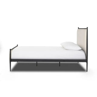 Side profile of the queen-size bed, showing its minimalist black metal frame and soft linen upholstery.